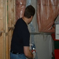 Image of a technician performing a low pressure epoxy injection of a foundation crack