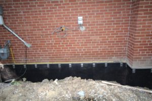 Appearance of waterproofed foundation wall prior to backfilling