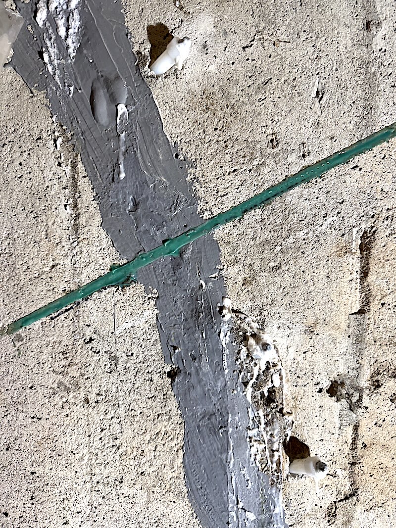 Carbon fibre stitch installed across a repaired foundation wall crack