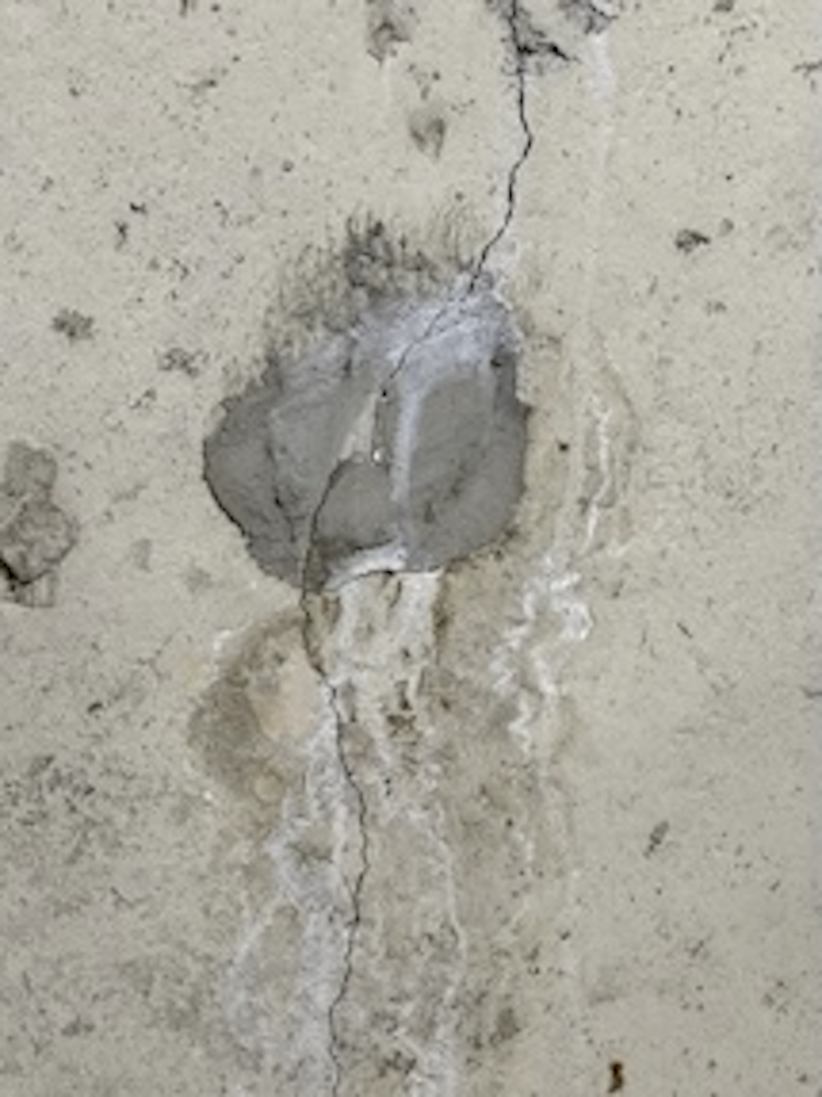 Leaking tie-rod hole with foundation crack in poured concrete wall