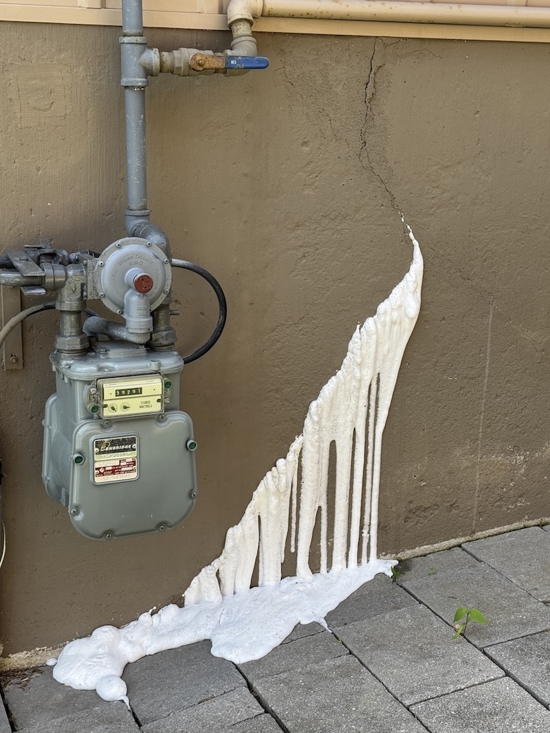 Polyurethane resin visible on the exterior side of a foundation wall during crack injection
