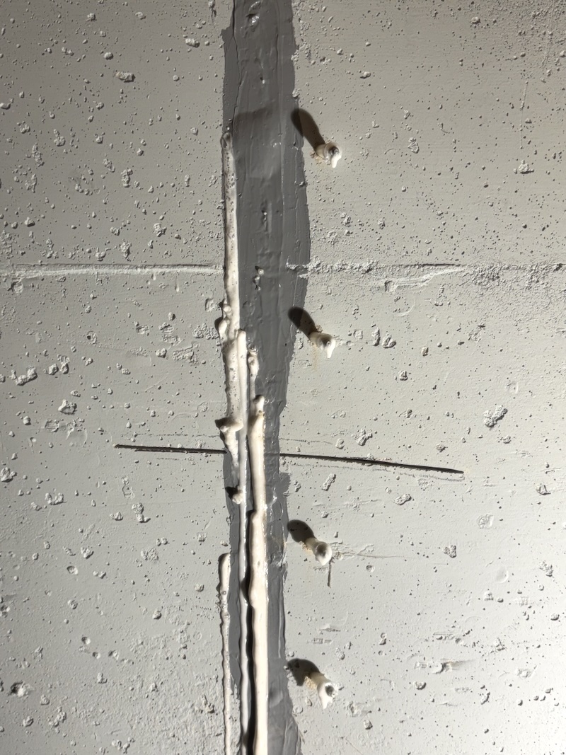 Polyurethane resin emerging from a foundation wall crack during injection