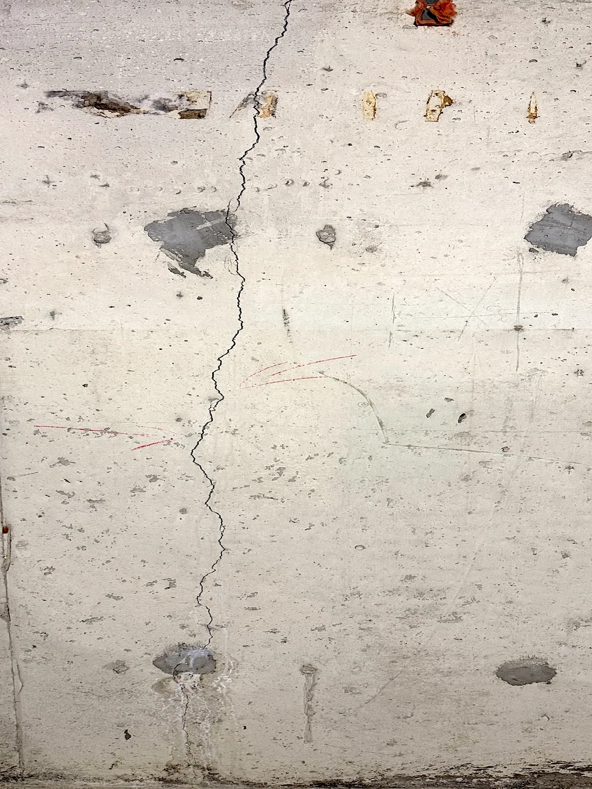 Vertical foundation crack in a poured concrete basement wall.