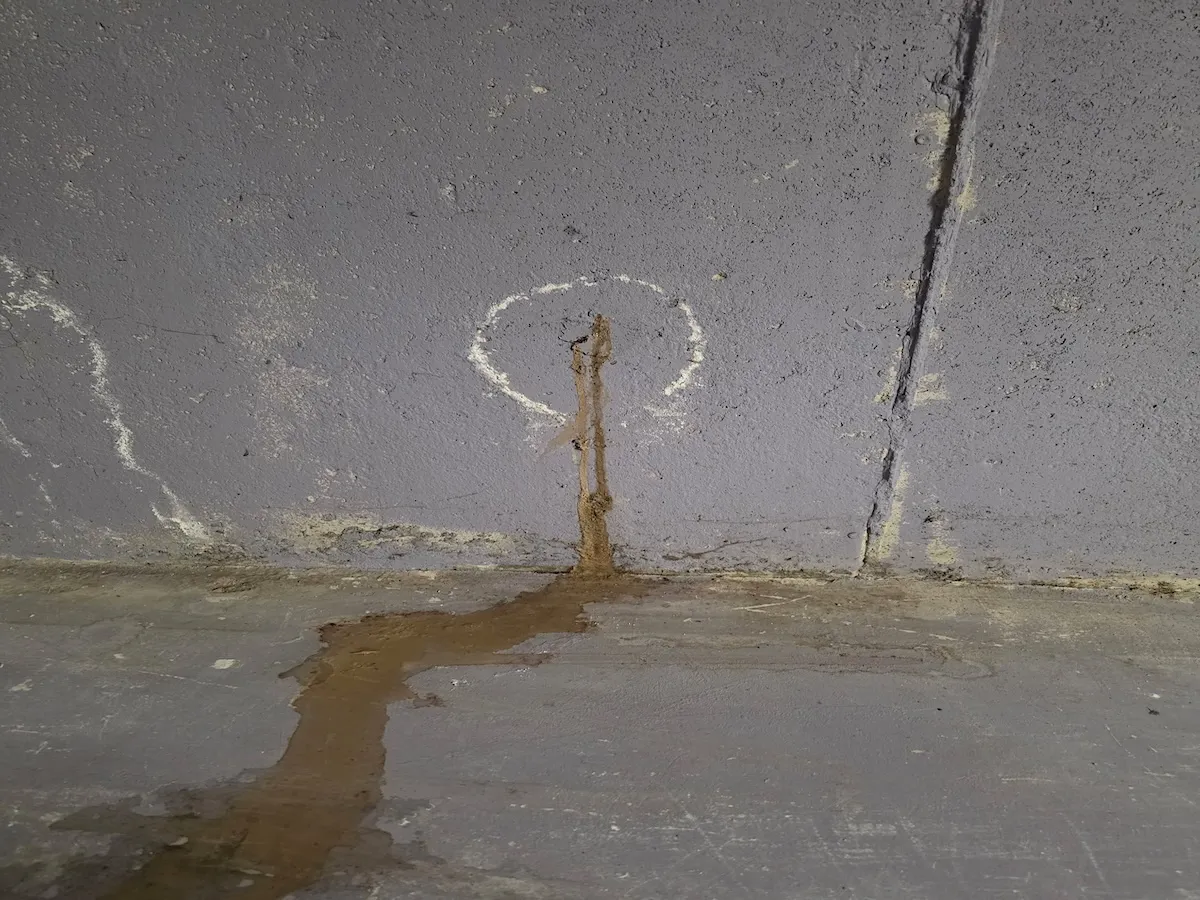 Leaking tie rod hole in a Newmarket basement with visible water staining