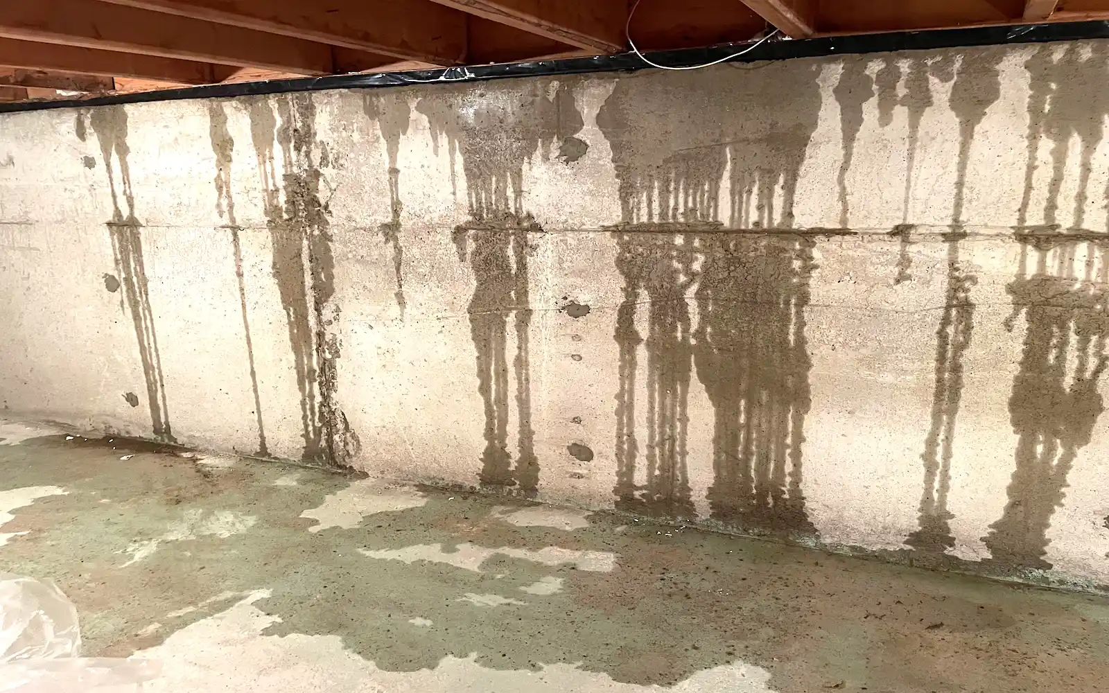 Water entering over the top of a poured concrete foundation wall